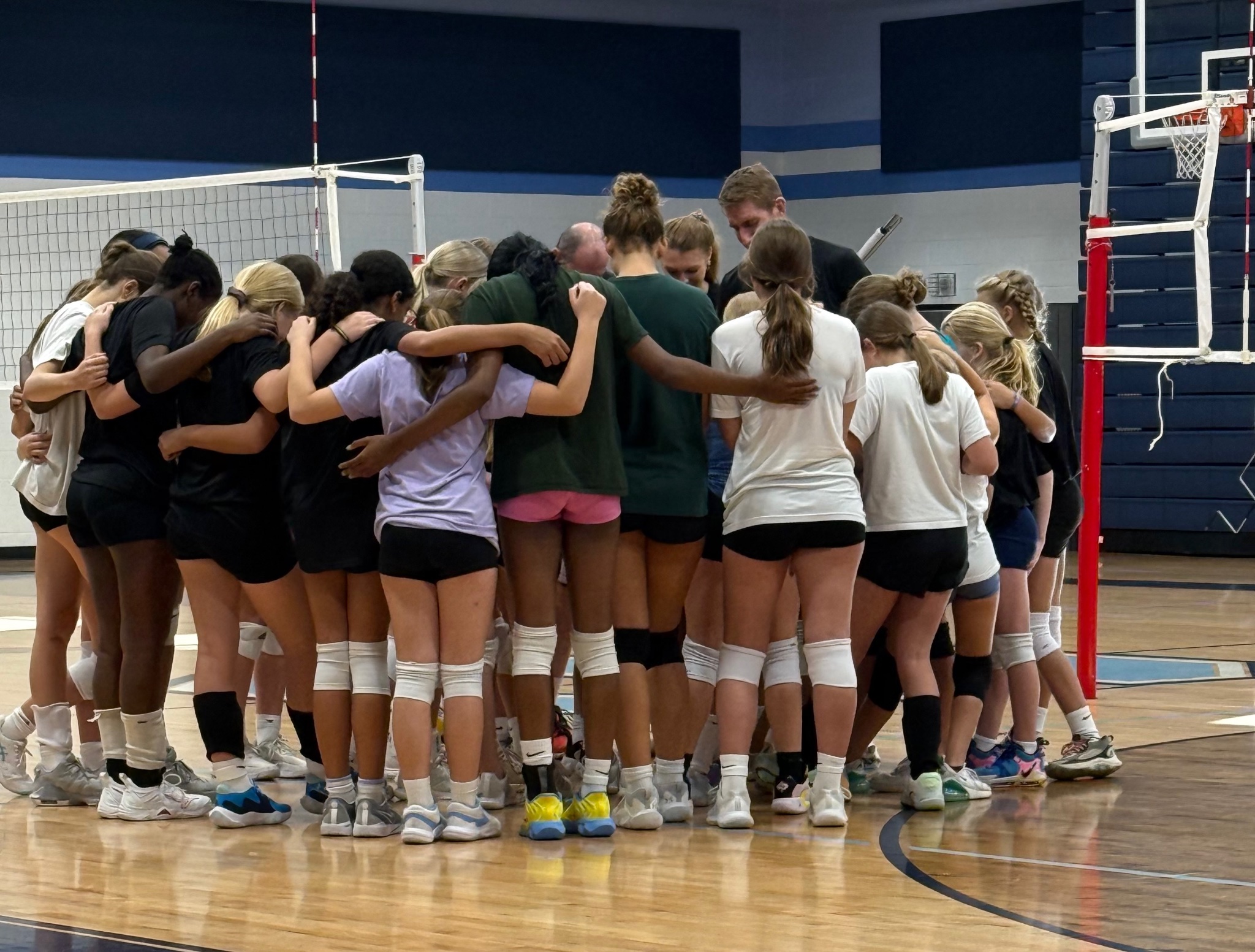 Team huddle in prayer